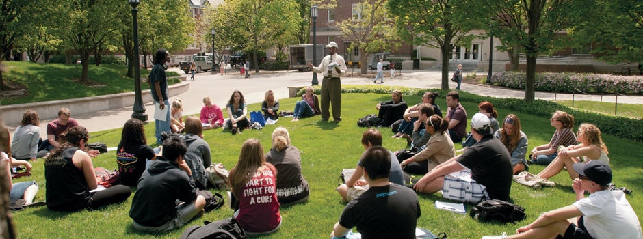 A professor addresses his class outdoors at Purdue University.