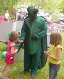 man in emerald ash borer costum meeting children