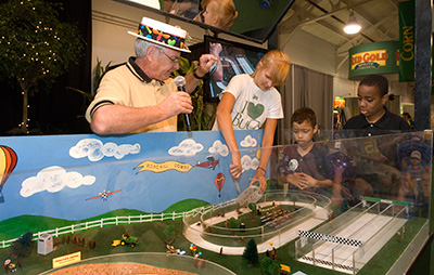 Purdue Entomology faculty member Arwin Provonsha leading the roach race at the Indiana State Fair